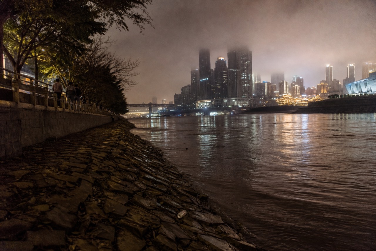 Illuminated skyscrapers of the Yuzhong peninsula rising above the Yangtze river at night