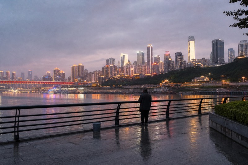 Blue hour on the Yangtze at Chongqing, the Yuzhong towers already lit while the last colour still fades from the sky above the river.